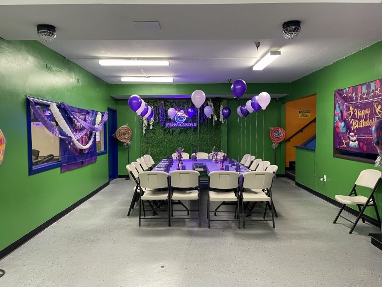 Gymnastics birthday party for kids, kids gymnastics party, Birthday Party room with green background and purple table decorations and setup. Purple balloons.