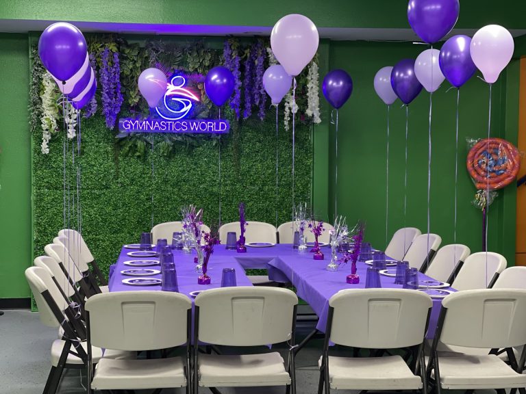 Gymnastics birthday party for kids, kids gymnastics party, Birthday Party room with green background and purple table decorations and setup. Purple balloons.