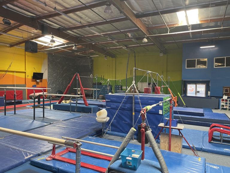 Gymnastics Facility with gymnastics equipment Colorful Mats - Bars area