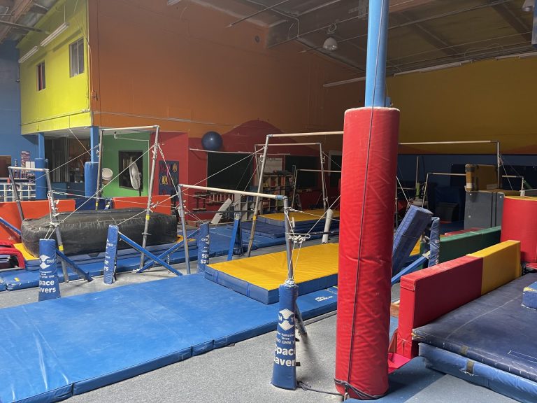 Gymnastics Facility with gymnastics equipment Colorful Mats - Uneven Bars Area