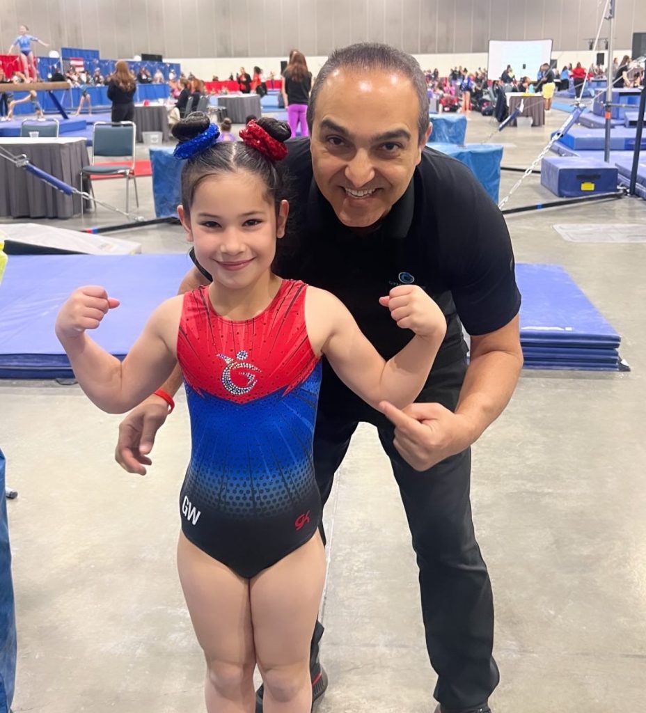Young Gymnast and coach celebrating